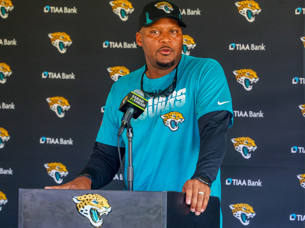 Mike Caldwell speaks at the podium after a Jaguars practice